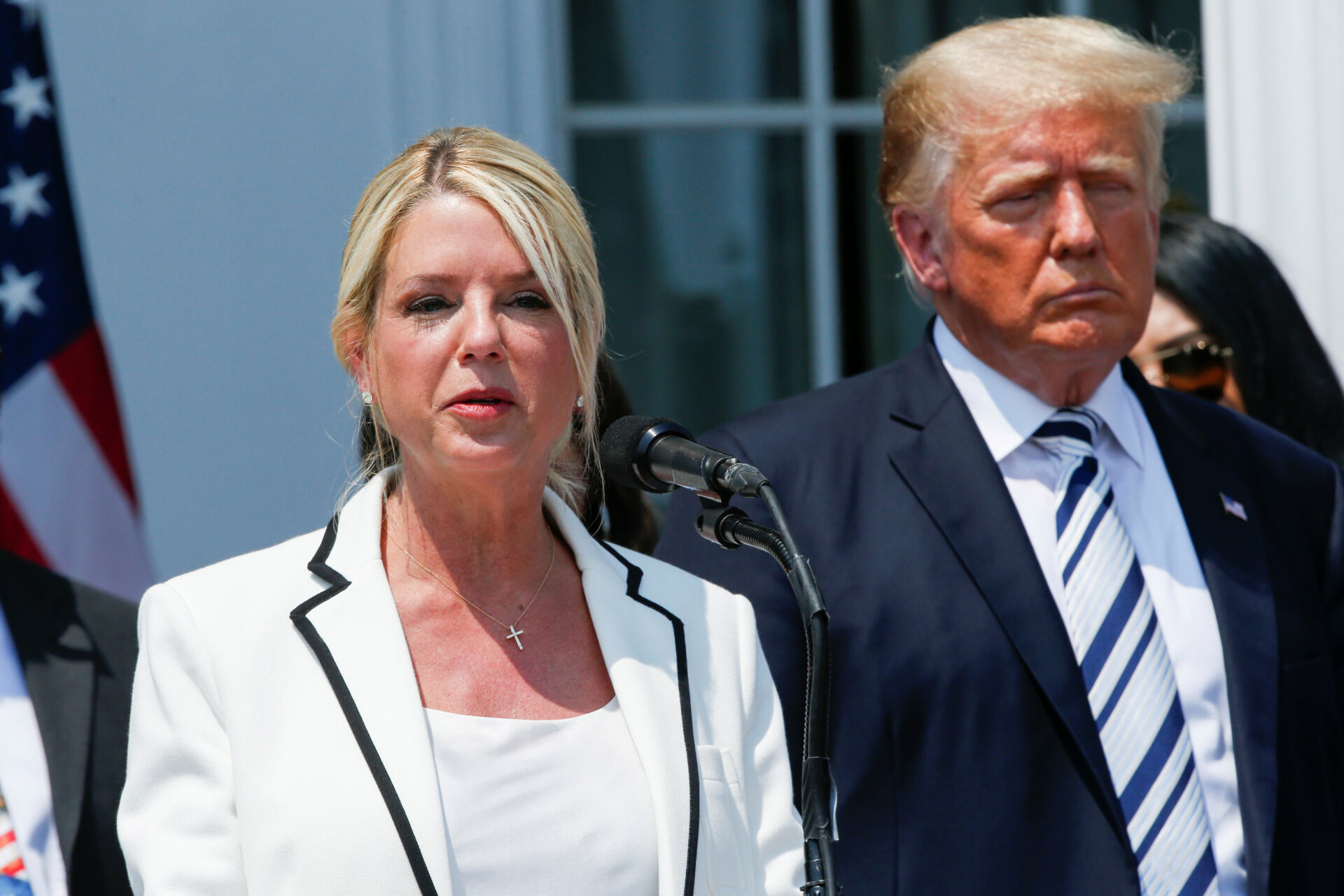 Former Florida Attorney General Pam Bondi speaks next to former President Donald Trump.